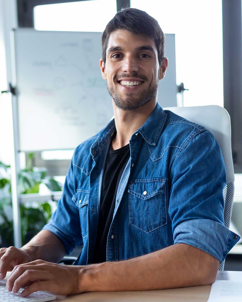 software developer looking at camera while working GHAS7B2